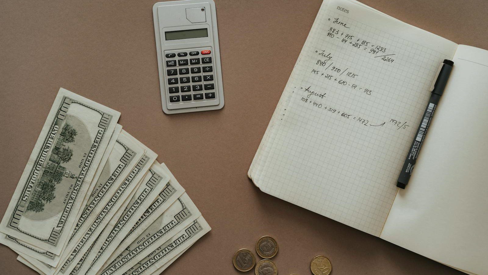 IT Spending Case Study: 7 Proven Ways We Cut Costs 30% 13 calculator notebook and cash representing a complete IT spending baseline for cost optimization