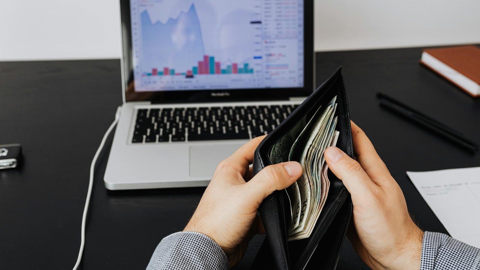 IT Spending Case Study: 7 Proven Ways We Cut Costs 30% 19 IT spending FAQ with wallet laptop and financial graphs for technology budget questions
