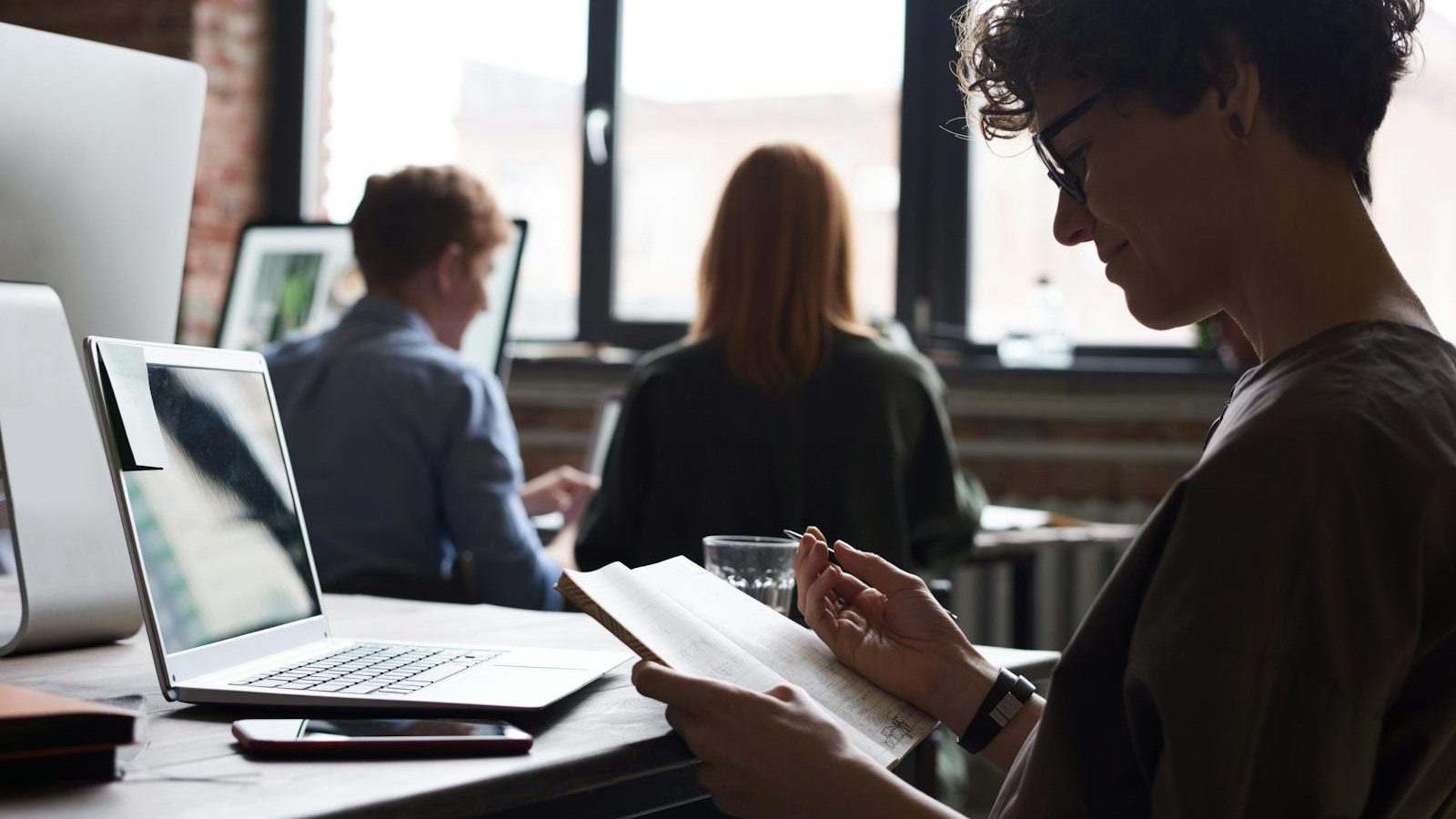 IT Spending Case Study: 7 Proven Ways We Cut Costs 30% 17 business team collaborating in an office representing IT cost governance and recurring review