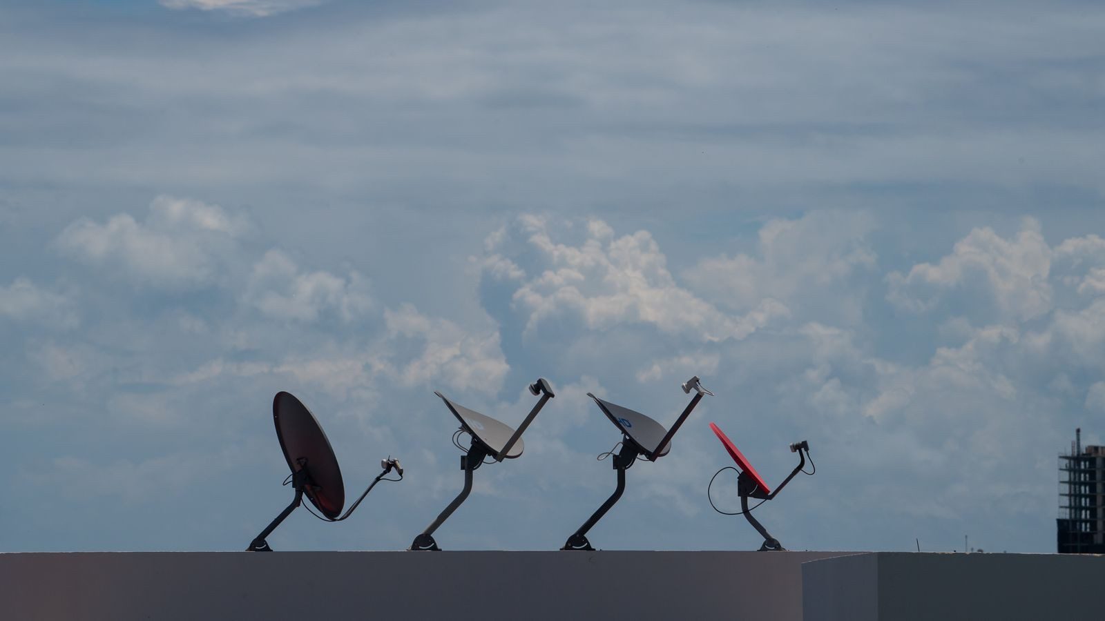 low earth orbit satellite networking enterprise backup: rooftop satellite dishes representing LEO satellite mesh enterprise backup paths