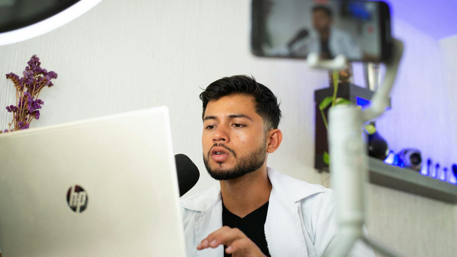 LiveSwap Review: 7 Smart Real-Time Face Swap Wins 12 creator using a laptop and phone to test browser based real-time face swap streaming