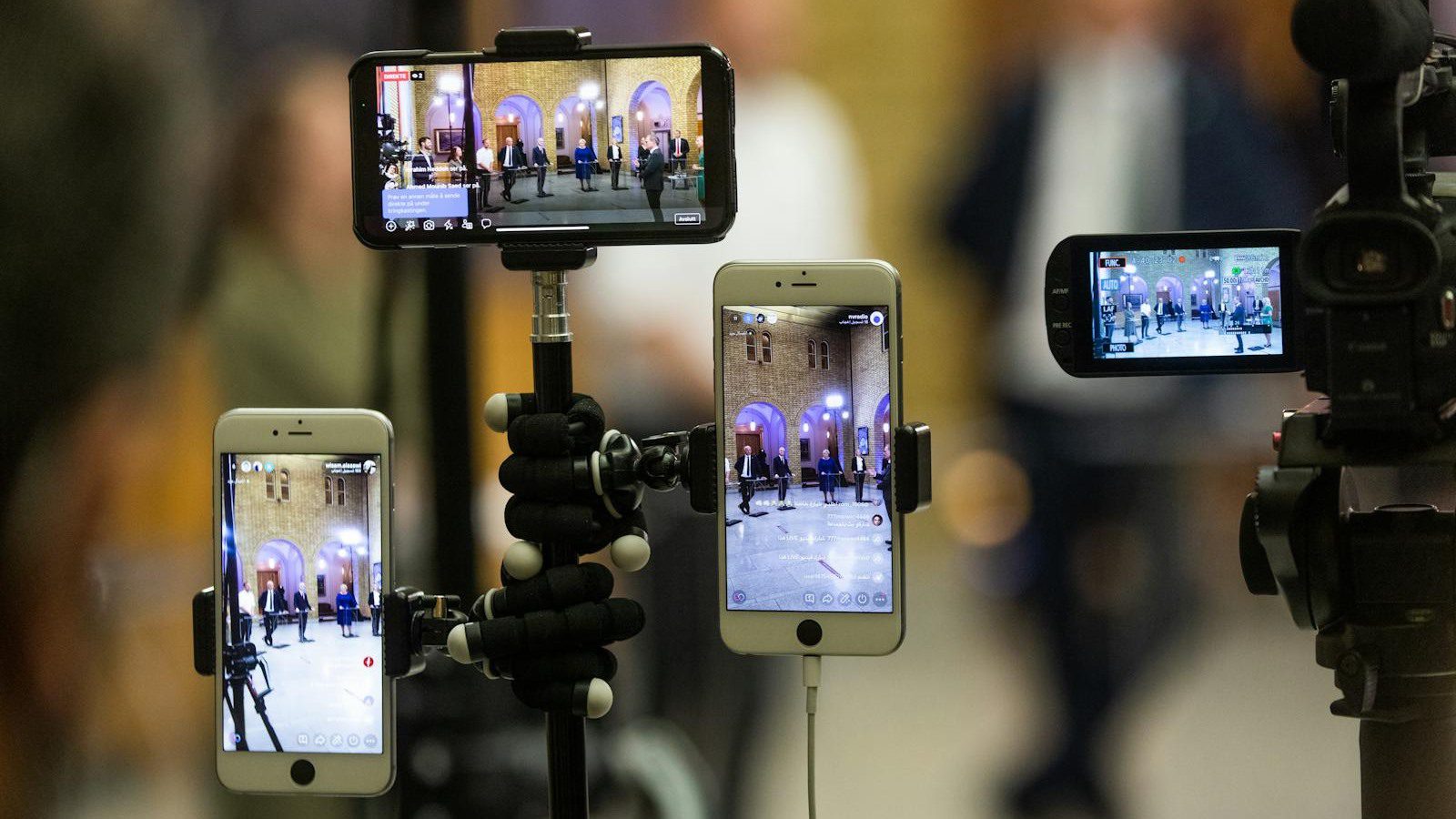 LiveSwap Review: 7 Smart Real-Time Face Swap Wins 18 multiple phones recording a live event representing disclosure consent and audience trust