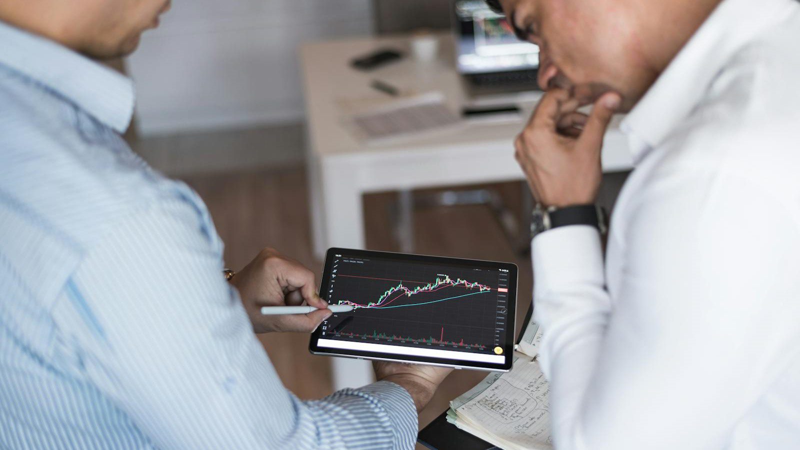 Mistral Medium 3.5: 7 Powerful AI Wins for 2026 18 professionals reviewing a digital tablet for future enterprise AI portfolio planning