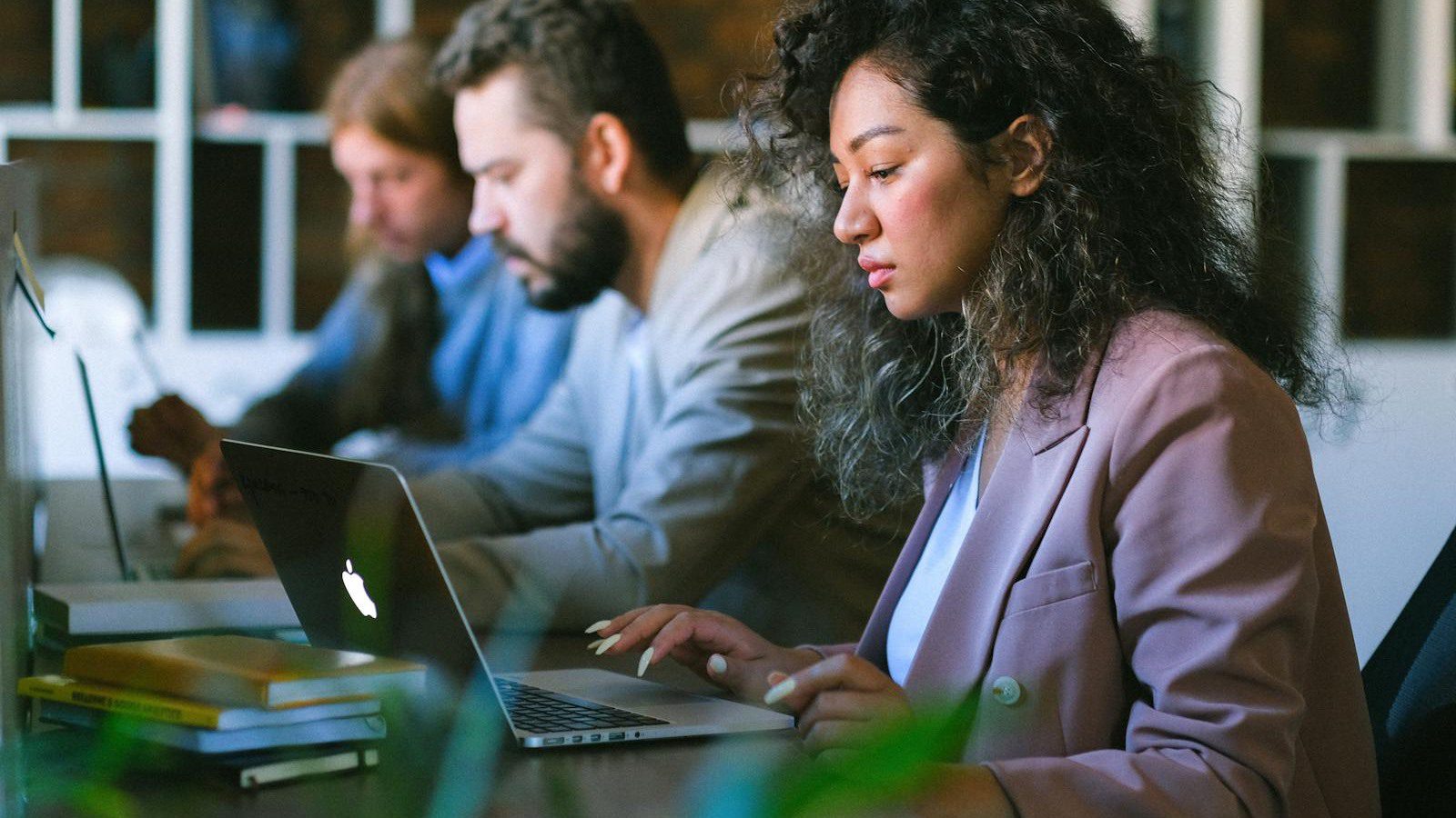 outgrown IT setup checklist with colleagues reviewing laptops and business technology workflows