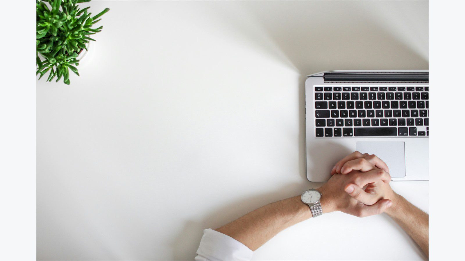 Remote Worker Laptops: 9 Easy Ways to Secure Them 21 person using a laptop carefully representing phishing training and unsafe link awareness
