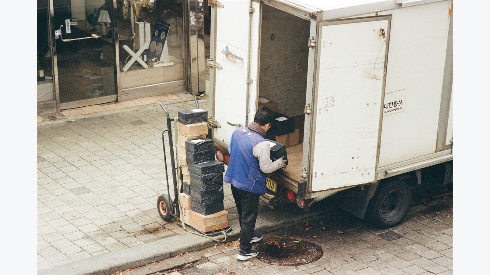 worker loading boxes from a truck representing logistics portal data mistakes to avoid