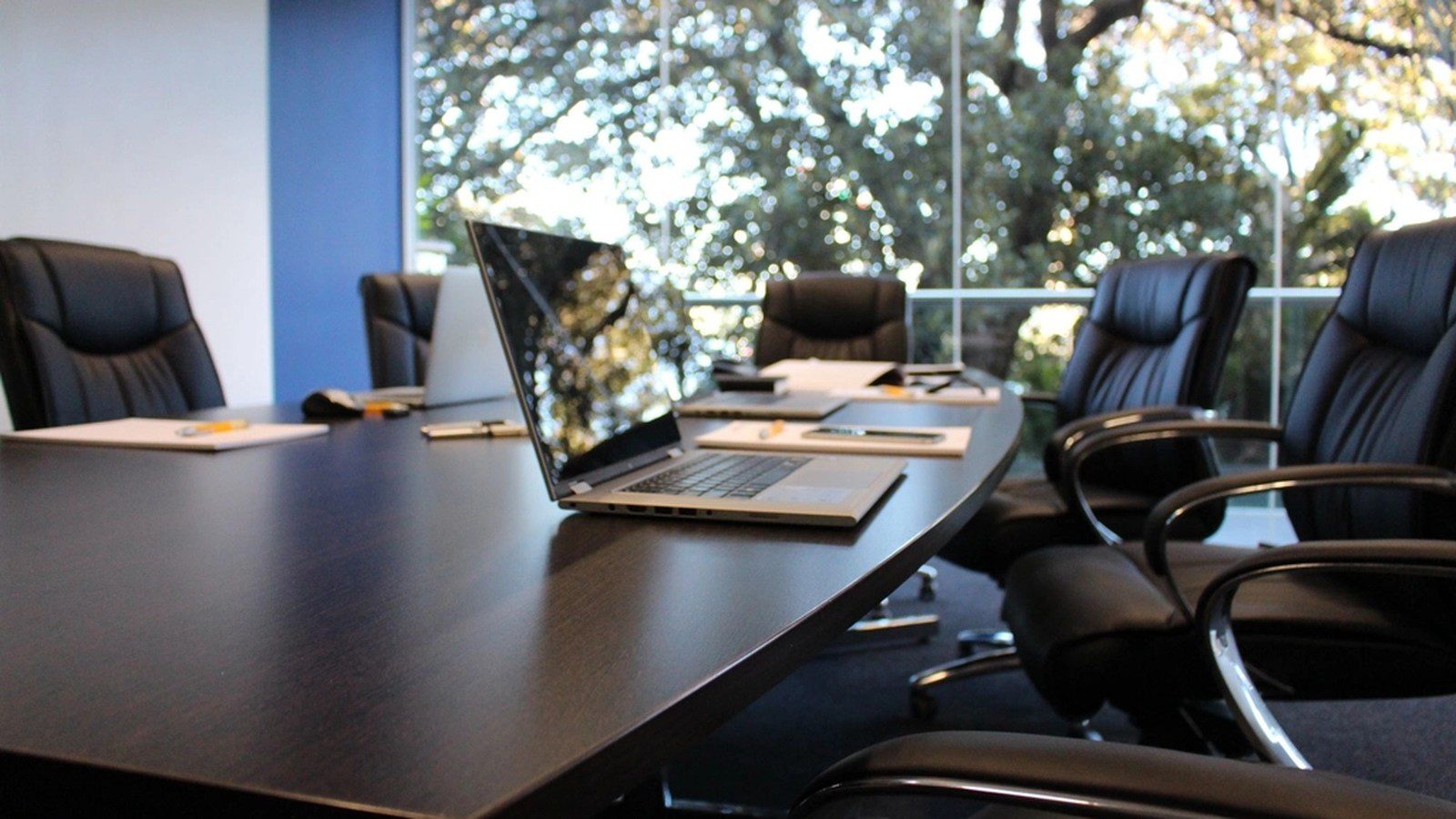 Smart Office Infrastructure: Wi-Fi 7 and IoT for Hybrid Work 9 Smart Office Infrastructure: green office building representing sustainable physical workplaces.