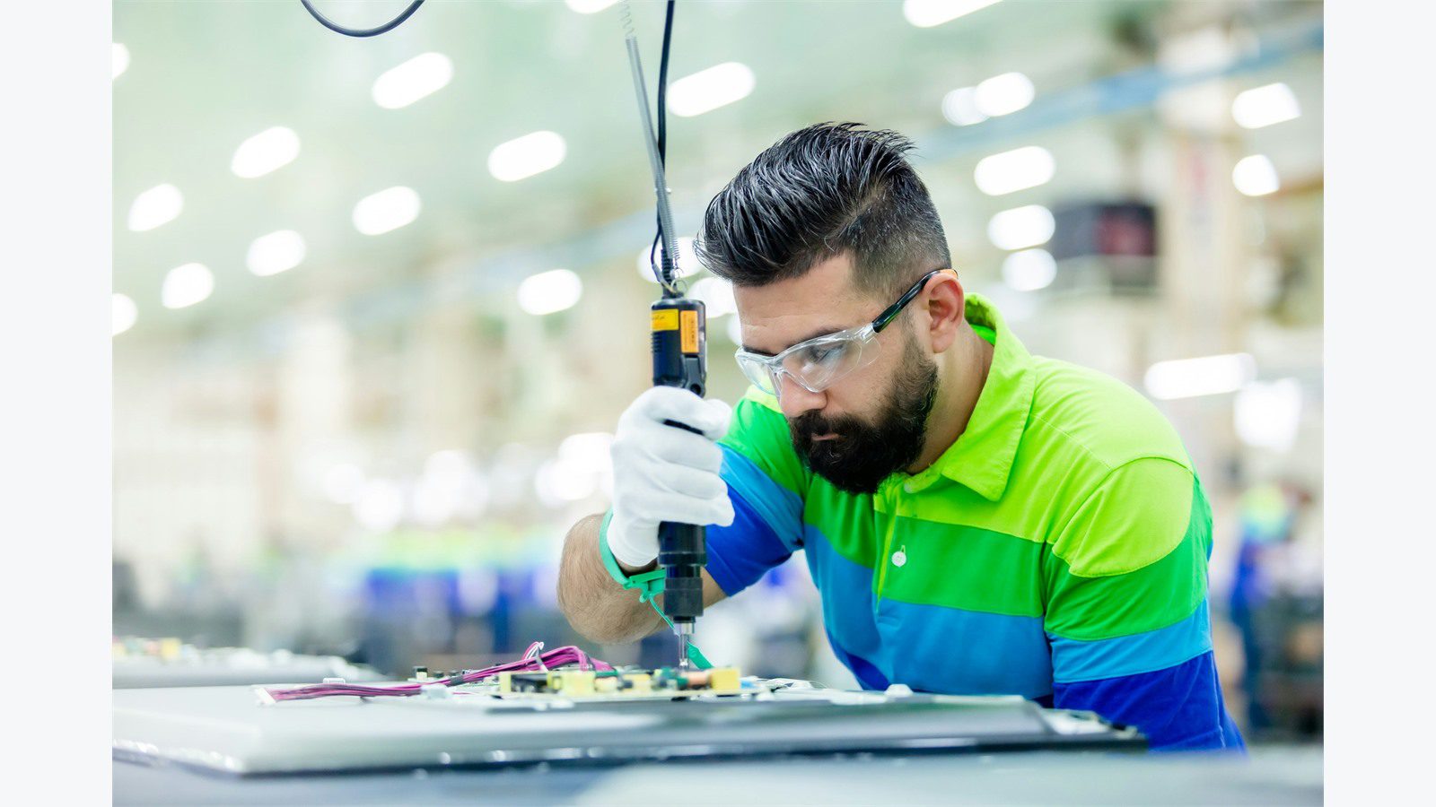 Smart Warehousing Uses IoT and AI: 9 Powerful Wins 18 technician inspecting industrial equipment for warehouse condition monitoring and predictive maintenance