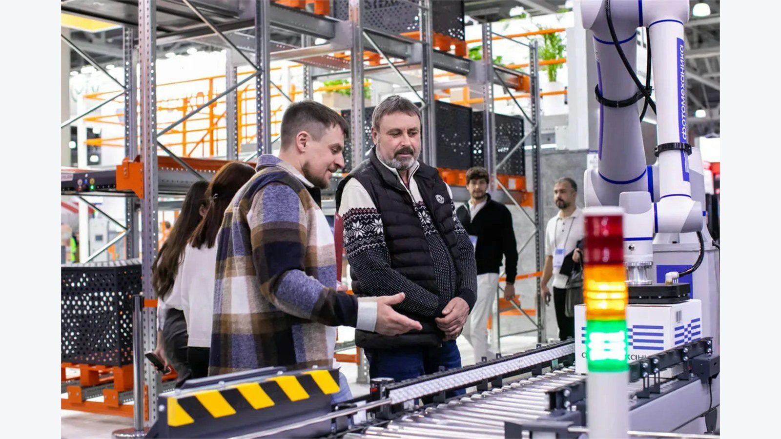 Smart Warehousing Uses IoT and AI: 9 Powerful Wins 16 warehouse automation line with workers and equipment coordinating AMRs conveyors and picking tasks