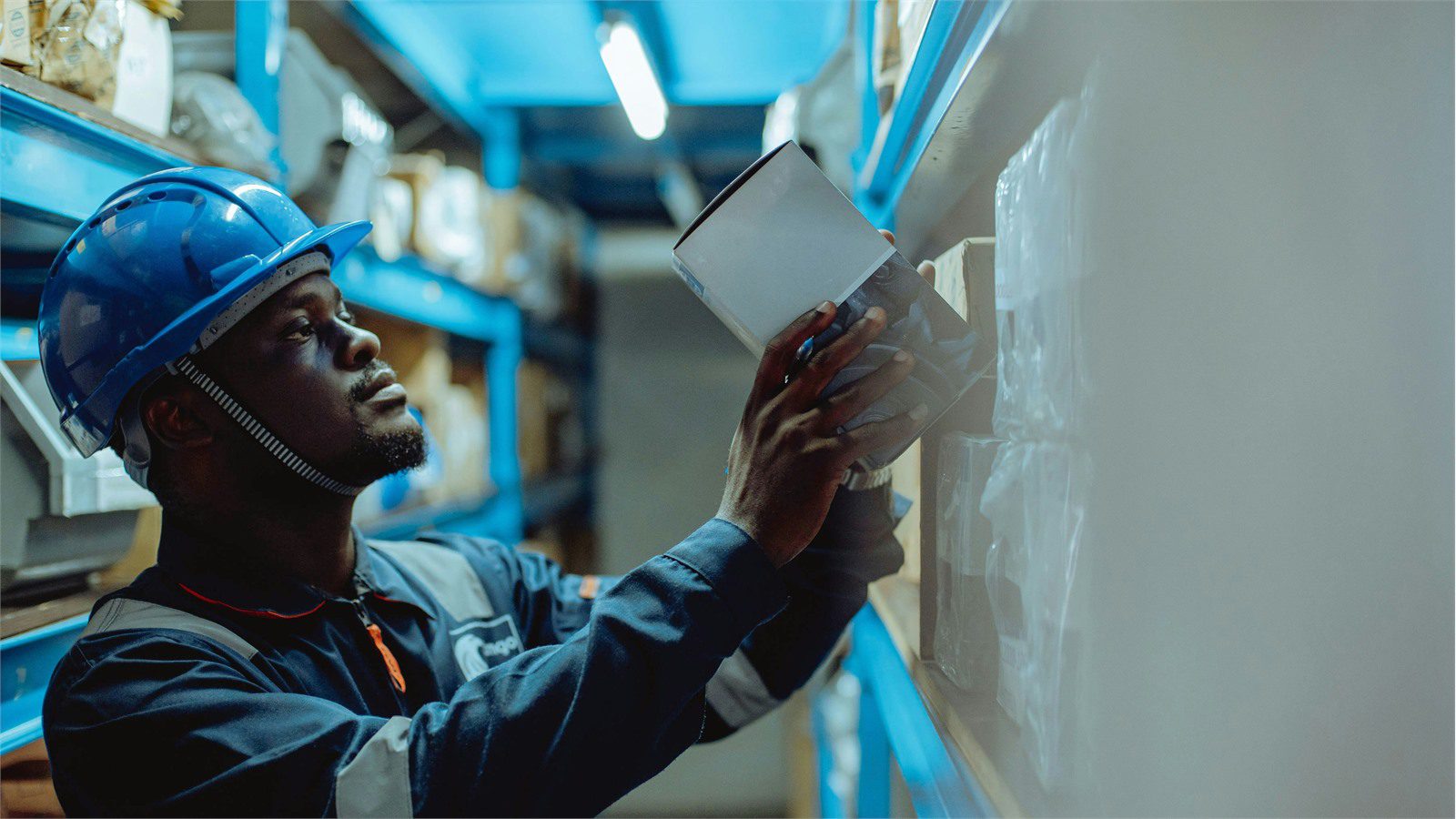Smart Warehousing Uses IoT and AI: 9 Powerful Wins 22 warehouse worker using a tablet on inventory shelves while planning a practical smart warehousing roadmap