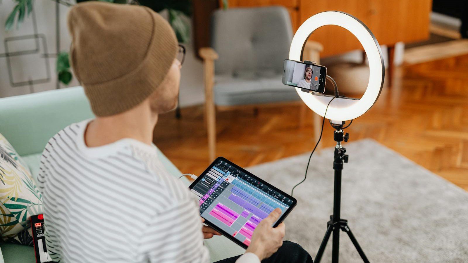 creator holding tablet near ring light representing mobile app access subscriptions and points