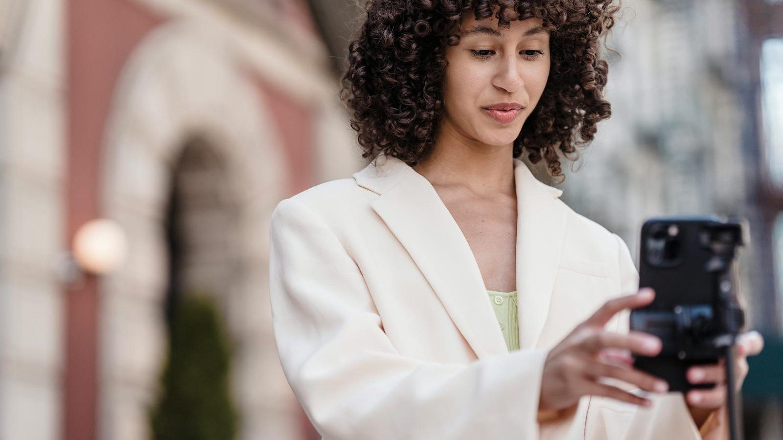 mobile creator preparing a smartphone shoot representing rollout plans for creators and brands