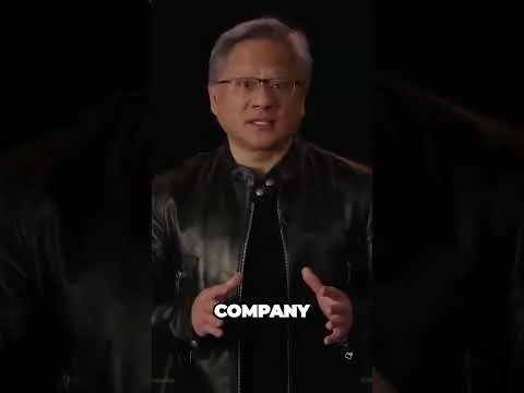 Progressive Robot, man in glasses and black leather jacket speaking on a dark stage with the word COMPANY on screen