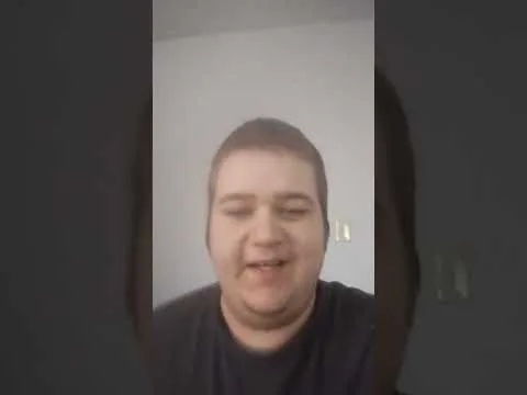progressive Robot selfie of a smiling person indoors against a plain wall