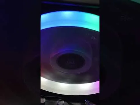 progressive Robot glowing RGB ring light around a dark circular fan inside a PC case