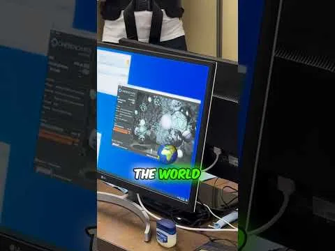 progressive Robot computer monitor displaying a world map graphic and the words THE WORLD on a desk