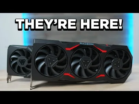 progressive Robot and three-fan Radeon graphics card on a desk with the text "THEY'RE HERE!" above it.