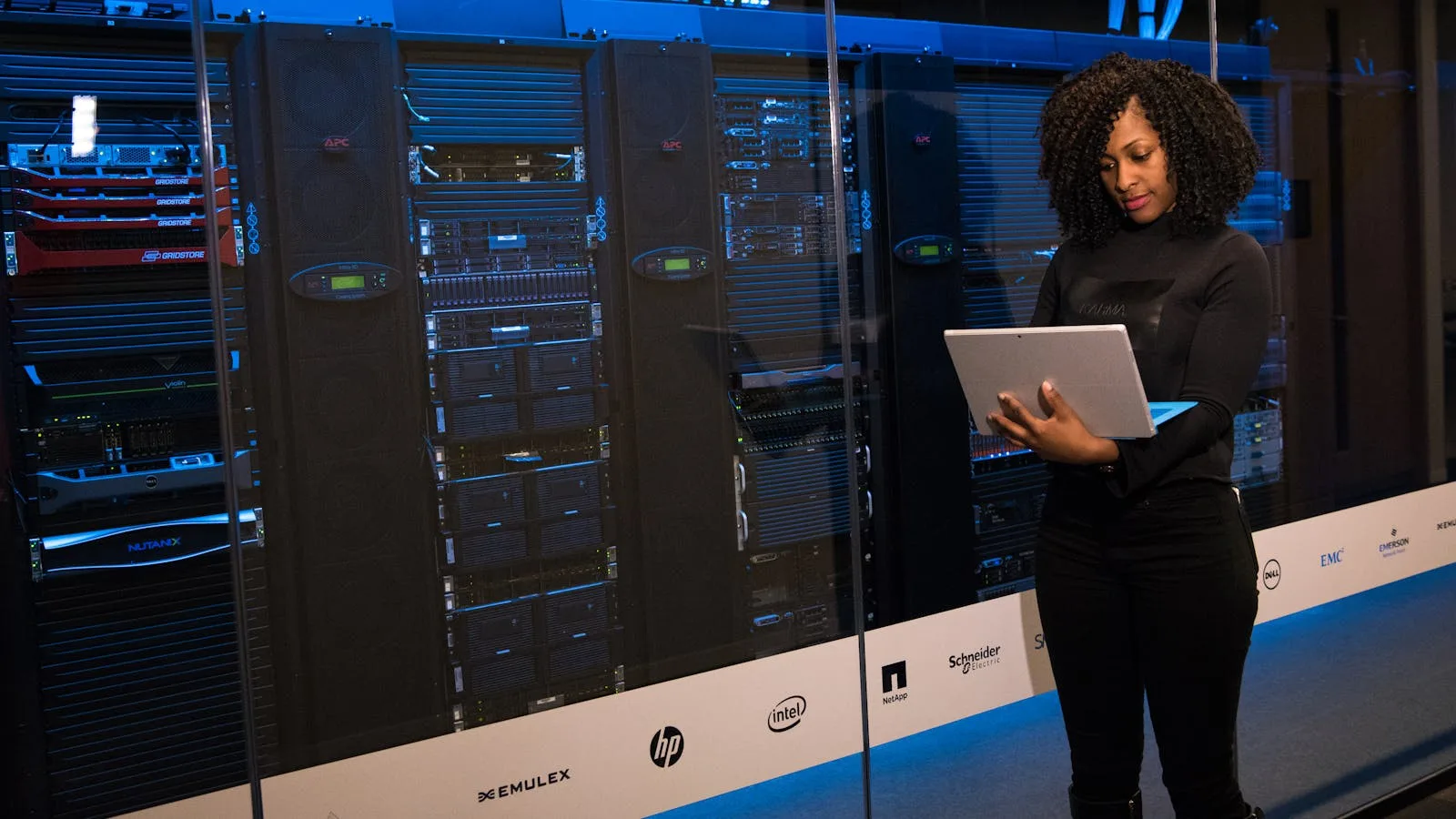 Allbirds Pivots to AI: 7 Facts Behind the NewBird AI Compute Bet 20 Engineer beside server racks representing the infrastructure focus behind the Allbirds pivots to AI story