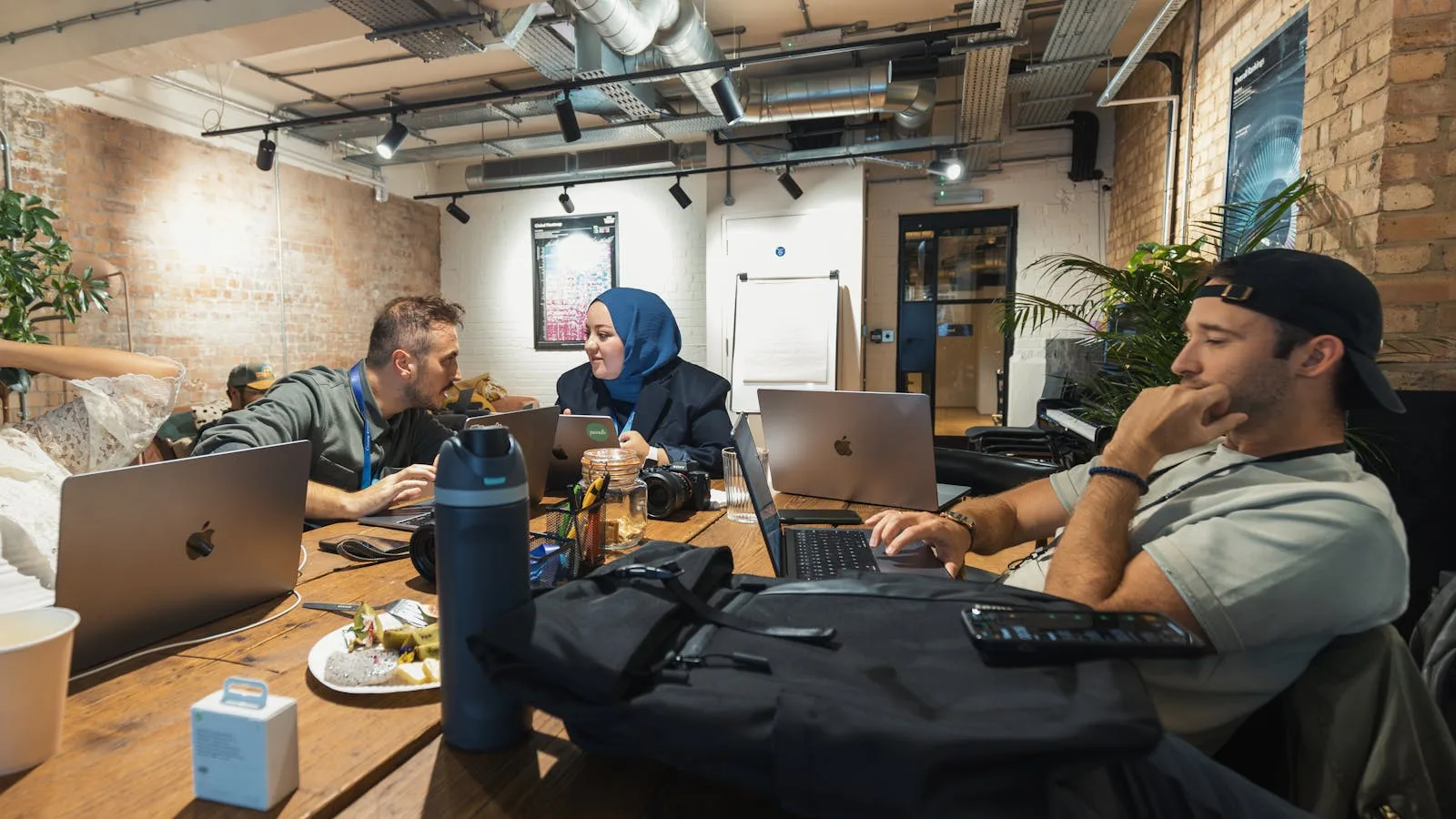 Allbirds Pivots to AI: 7 Facts Behind the NewBird AI Compute Bet 24 Modern office discussion scene representing common questions about the Allbirds pivots to AI story