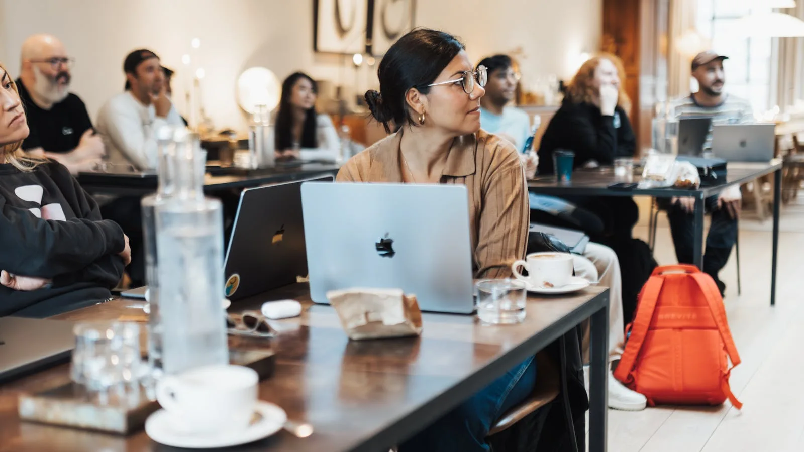 Atomic Bot: 7 Useful Facts About the OpenClaw AI Assistant 22 A team meeting with laptops representing why action-taking AI assistants matter in daily work