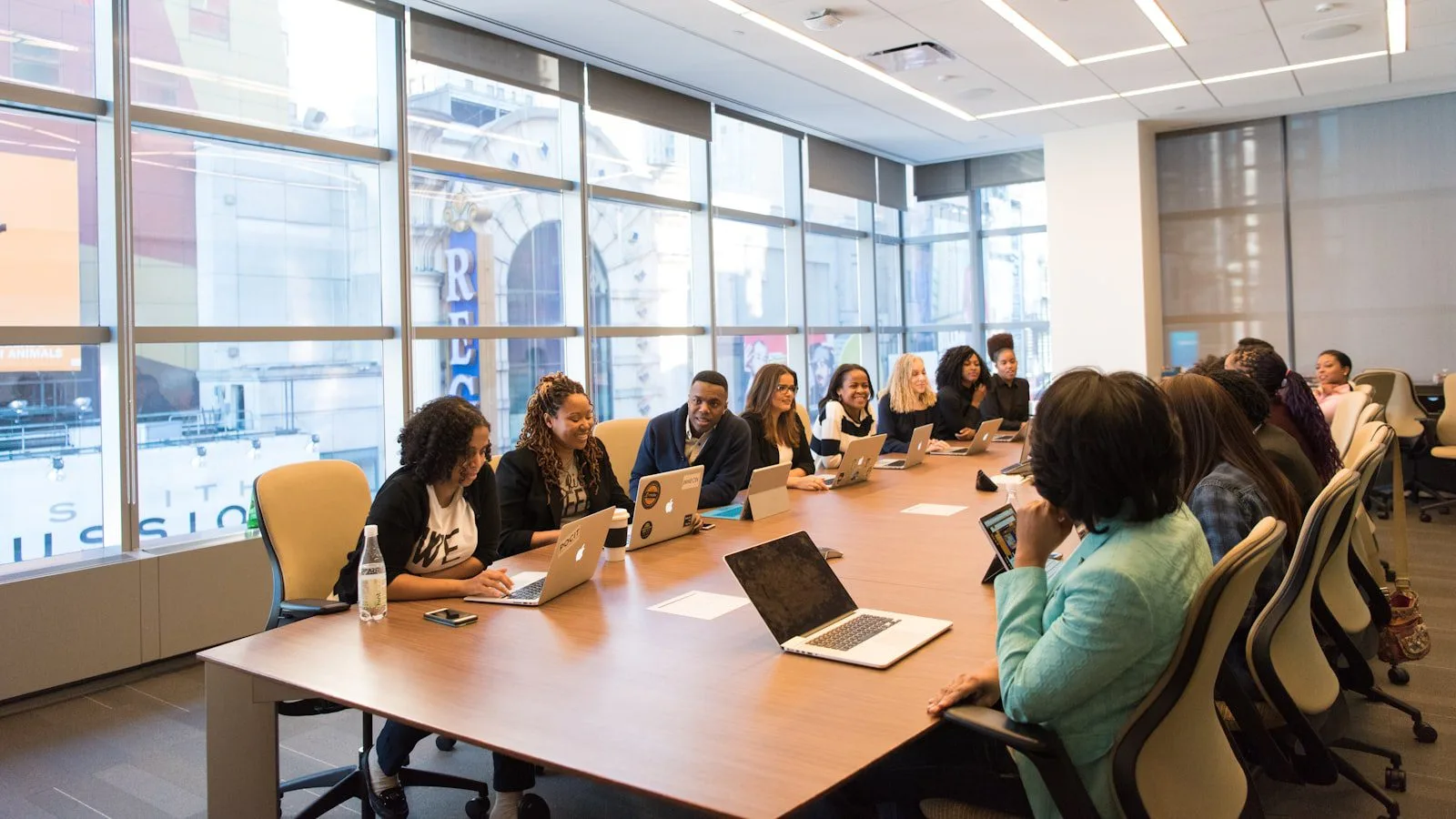 GPT for Work at a glance represented by a team using laptops around a meeting table