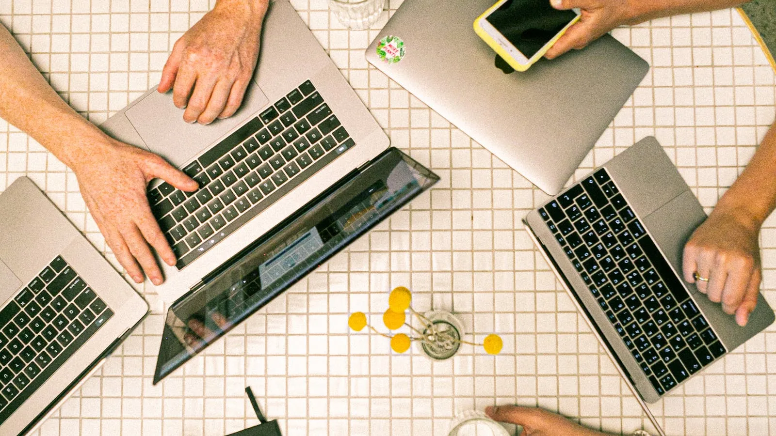 GPT for Work represented by a team collaborating across laptop-based workflows in an office