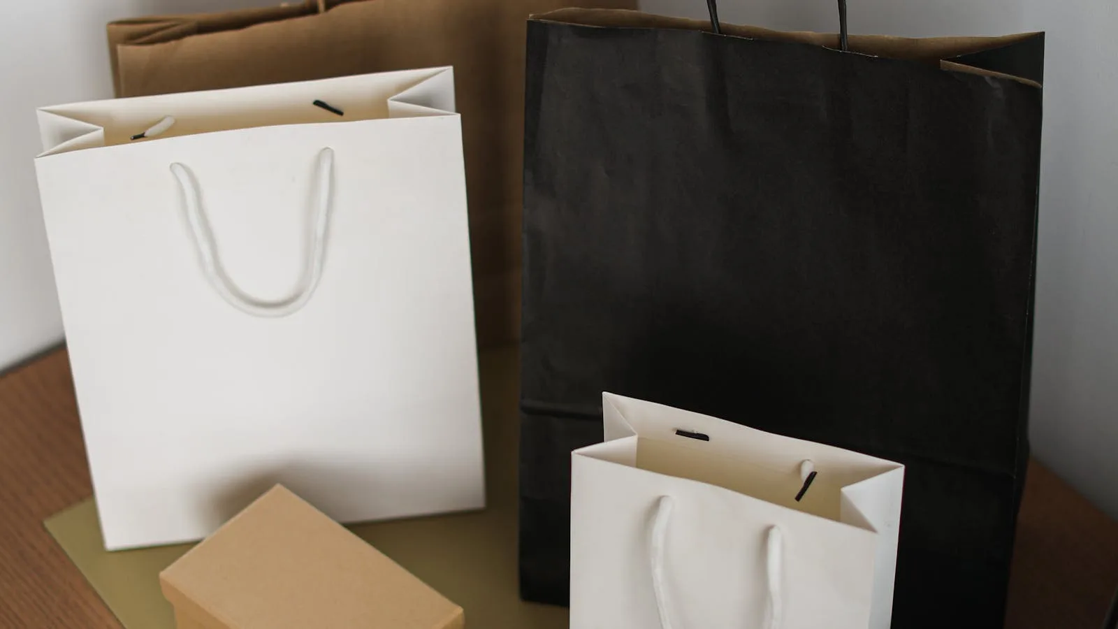 What Is PresentButler? 7 Helpful Facts About the AI Gift Finder 27 What is PresentButler still limited by represented by shopping bags and a laptop on a wooden table