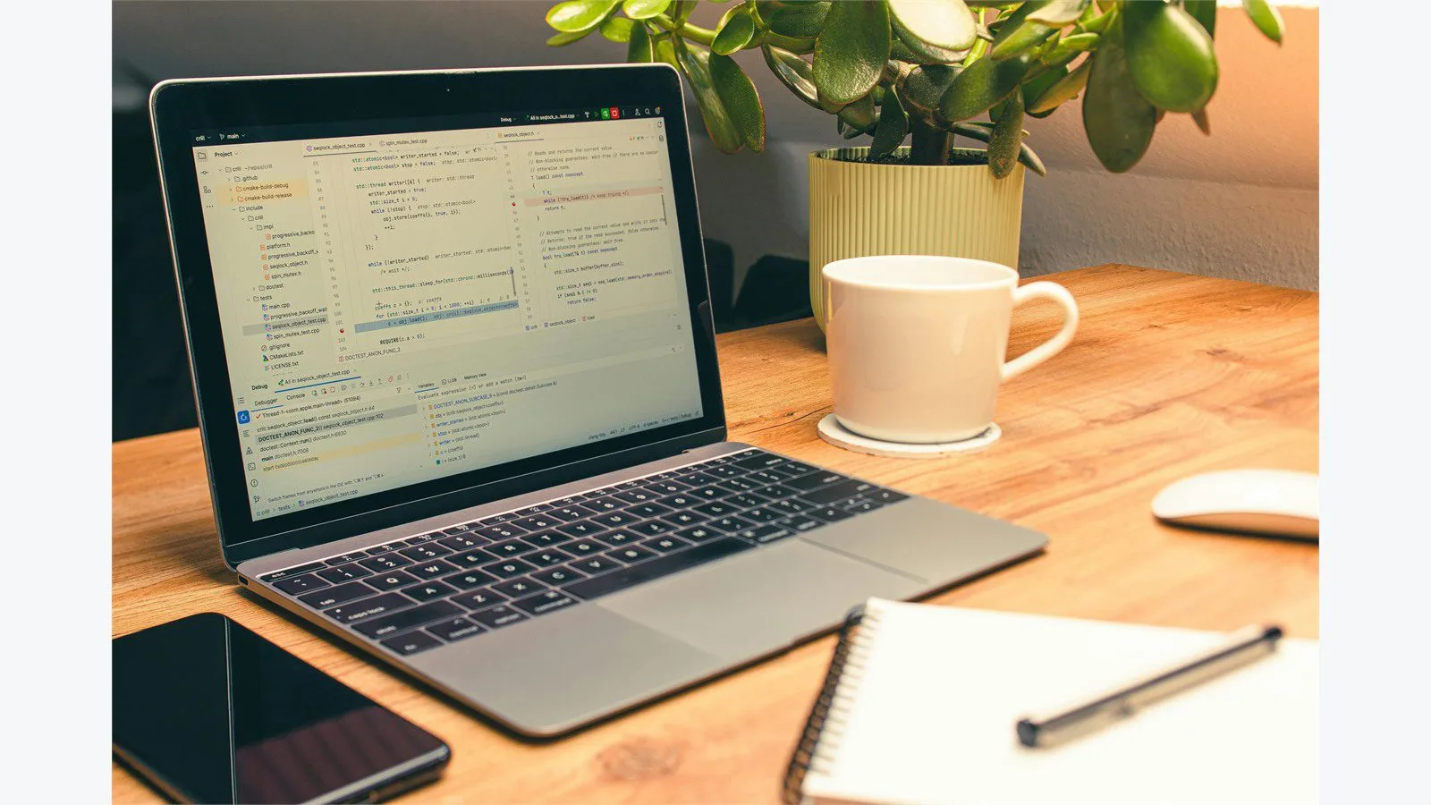 Adobe FrameMaker workspace with laptop, notes, and documentation tools on a clean desk