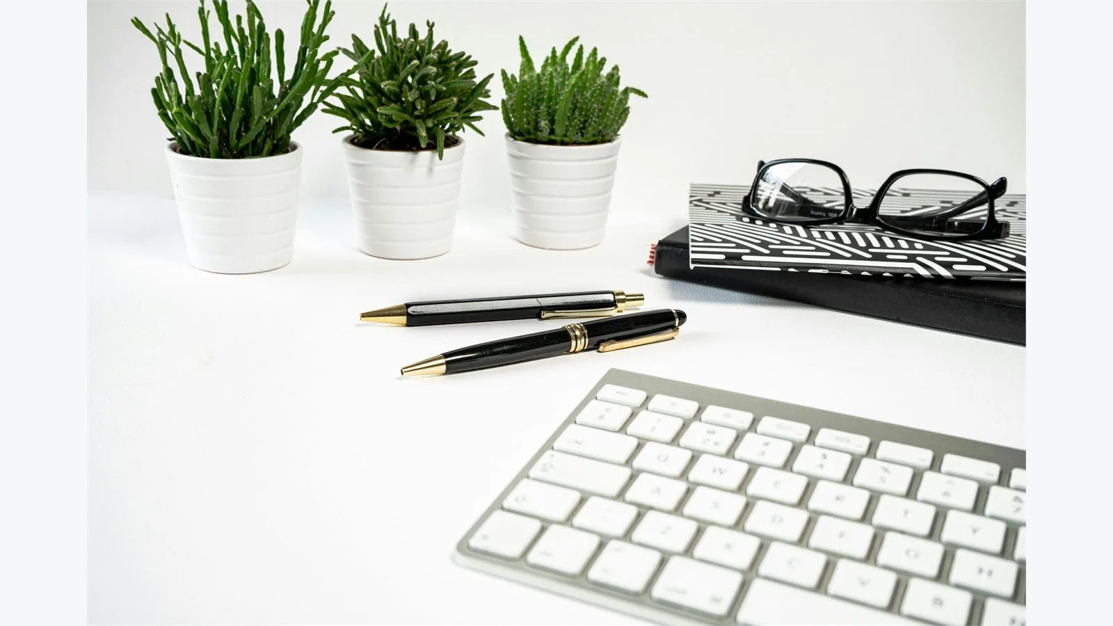 What Is Adobe FrameMaker? 7 Essential Facts for Beginners 11 Structured writing workspace with notebook, keyboard, pens, and desk accessories