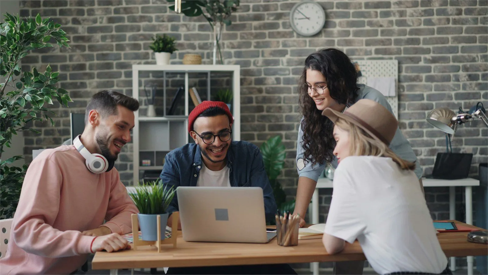 AdsCreator.com: 7 smart ways to launch winning ads 13 Multi-format ad planning concept with a team reviewing documents and laptops at a meeting table