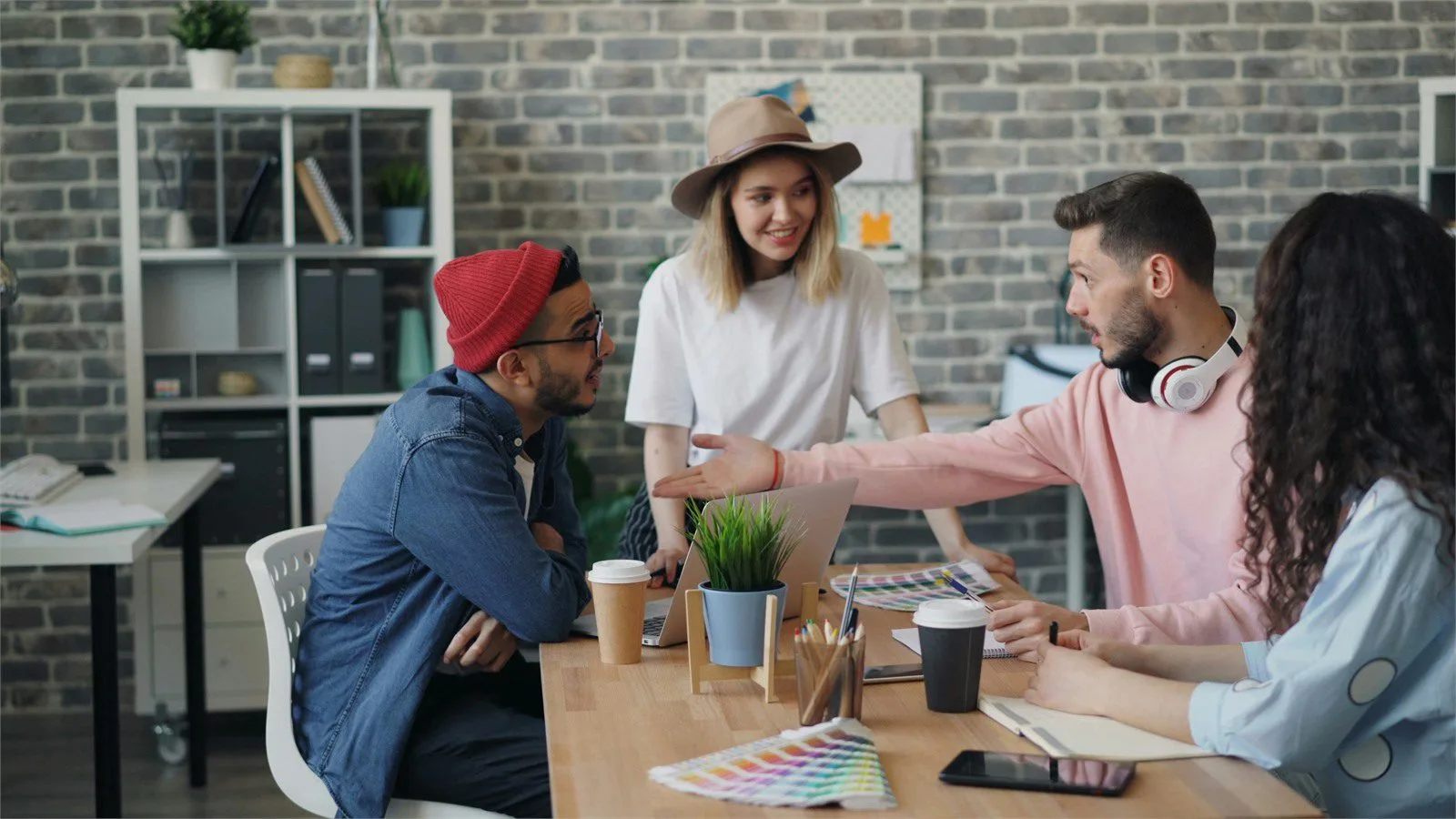 AdsCreator.com: 7 smart ways to launch winning ads 12 Brand DNA review concept with marketers comparing color swatches and laptop creative cues