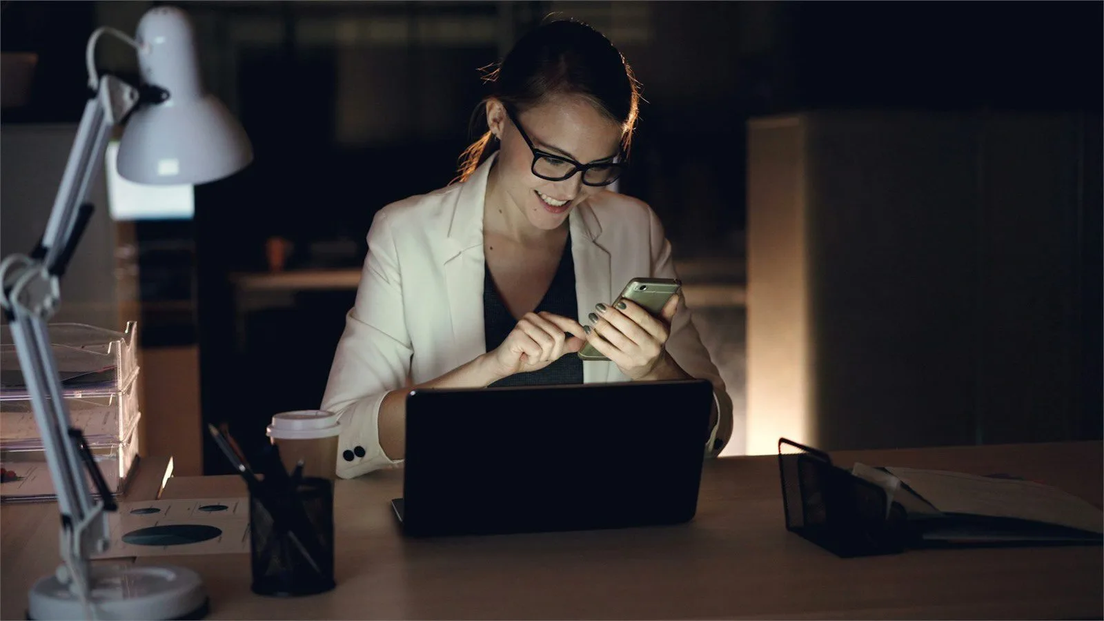 After-hours phone and laptop workflow representing common Gmail AI questions