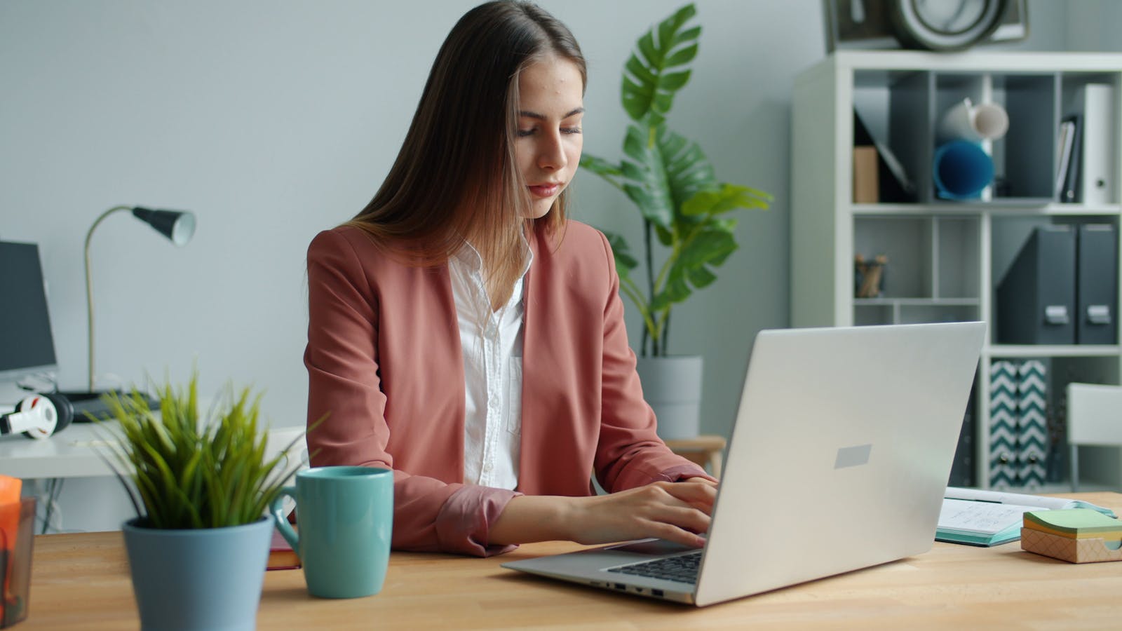 AIOps ROI for Helpdesks: 7 Powerful SMB Payback Wins 14 Helpdesk analyst working on a laptop as SMB support demand grows