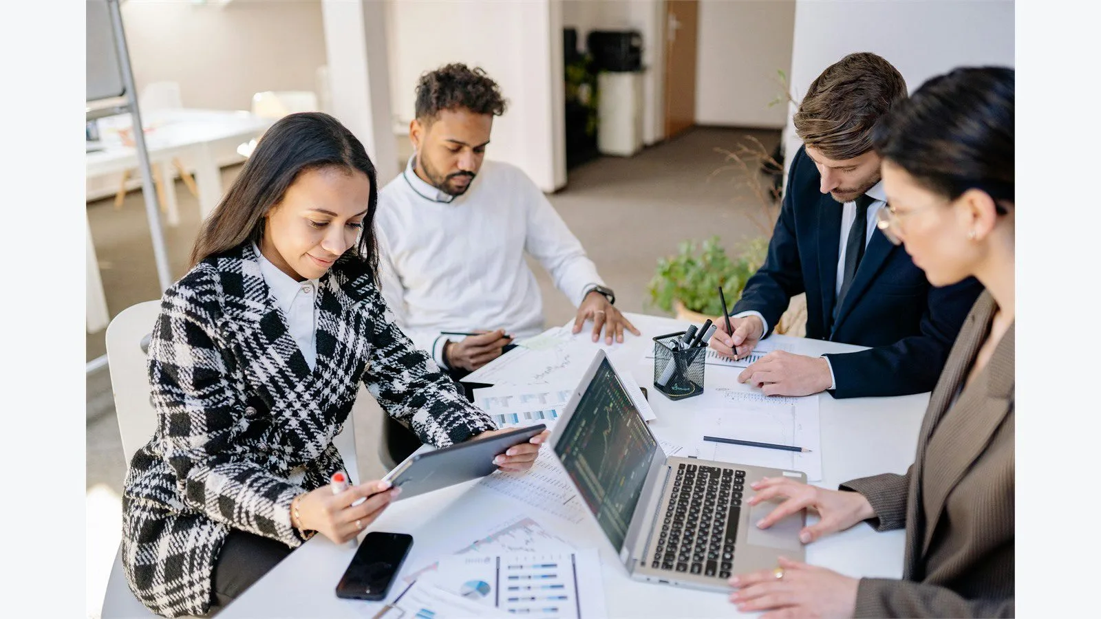 AngularJS End of Life in 2026: 7 Smart Moves for Legacy Apps 12 Team planning modernization choices for a legacy software platform at a shared table