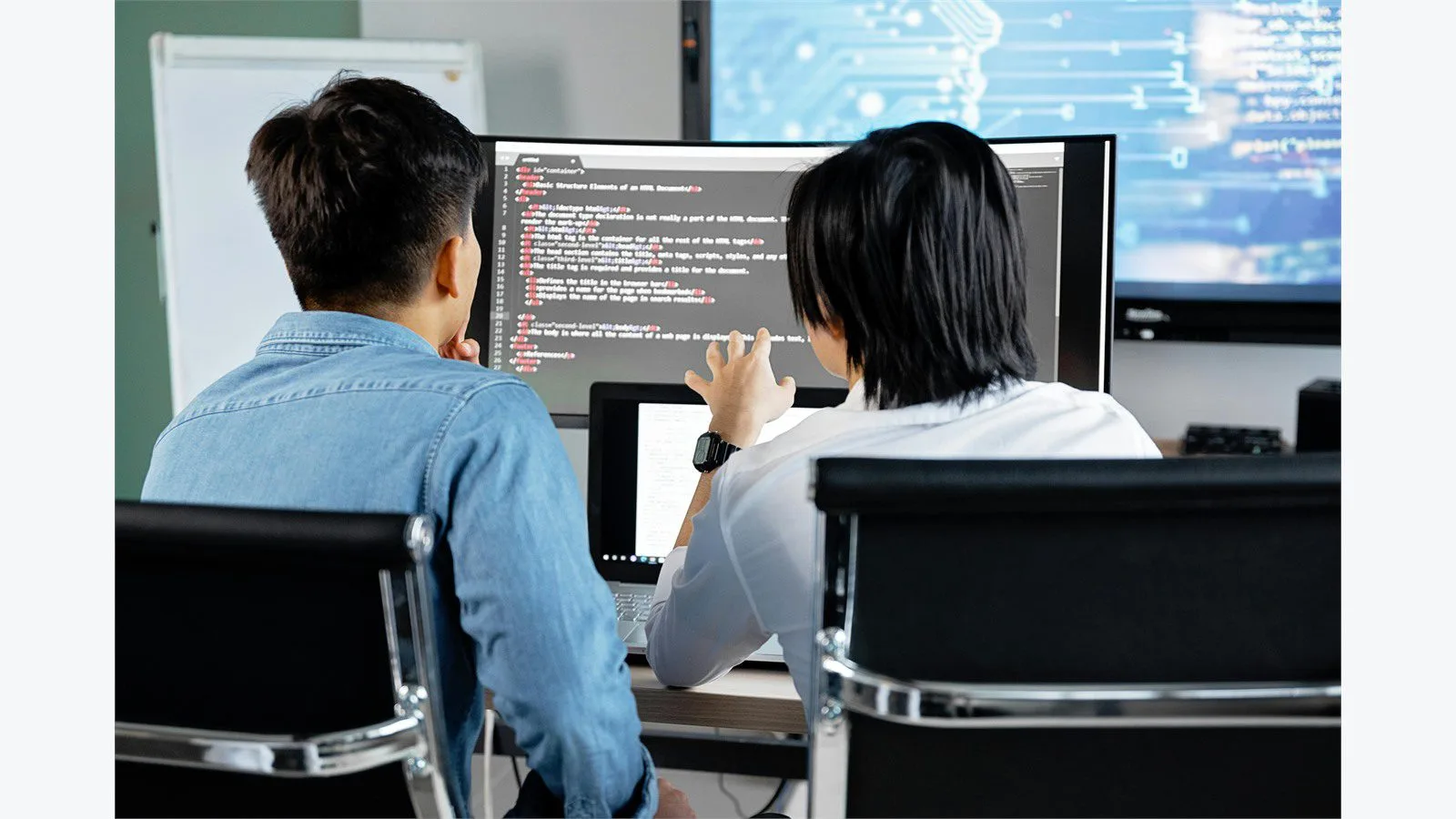 AngularJS End of Life in 2026: 7 Smart Moves for Legacy Apps 14 Two developers discussing code on a monitor while planning a phased migration