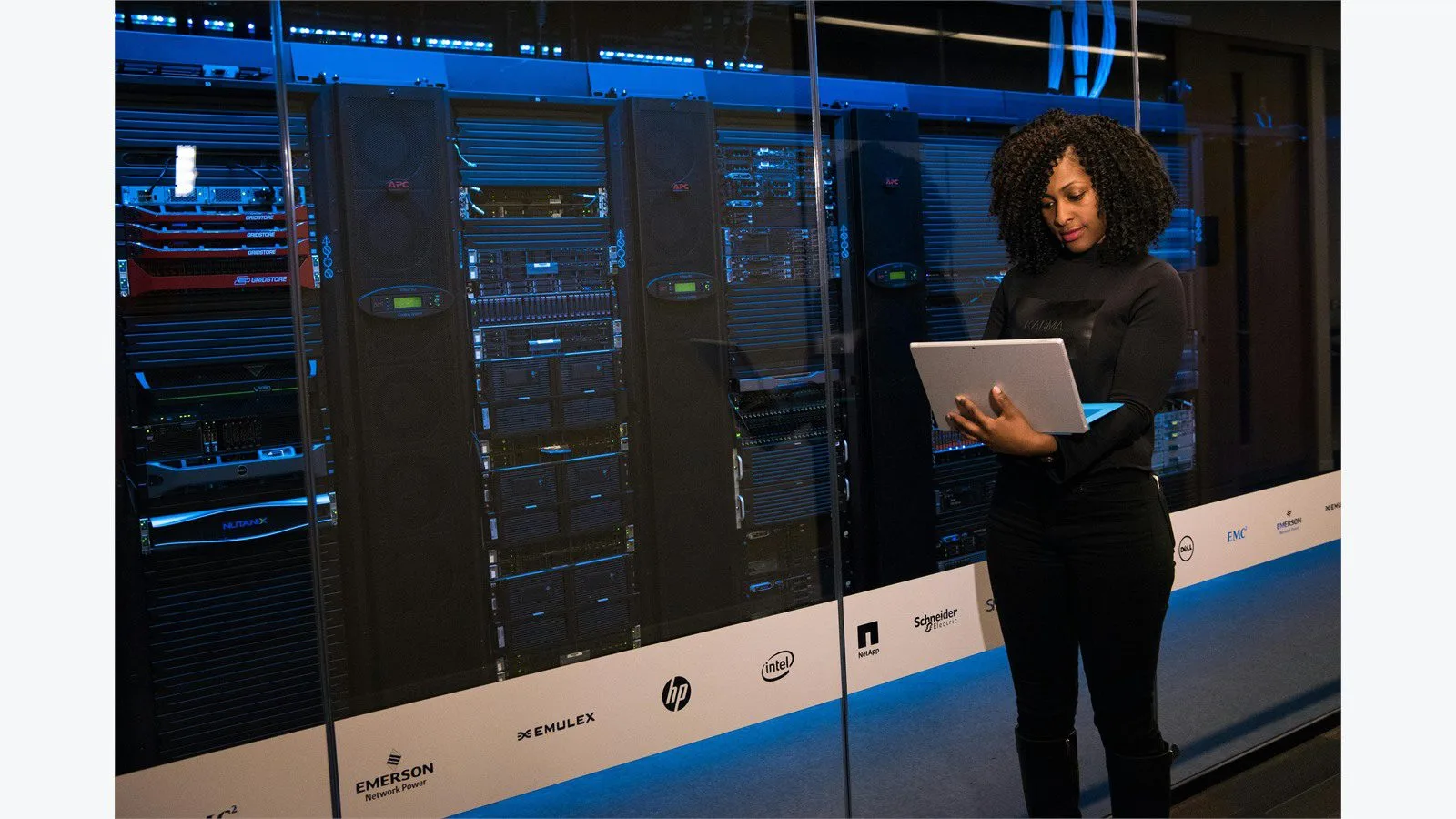 Engineer monitoring servers while reviewing legacy app infrastructure risk
