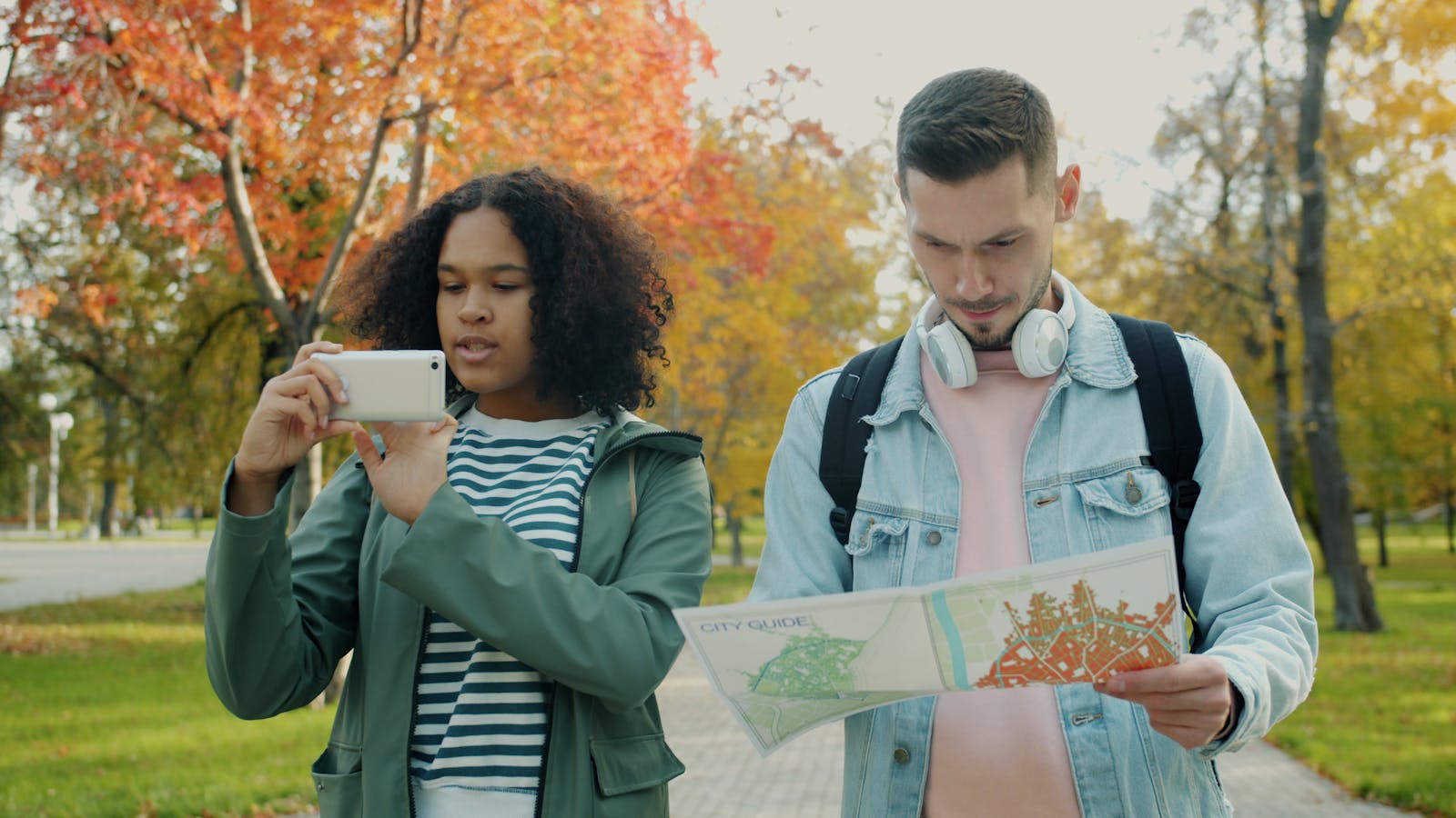 Ask Maps: 7 Powerful Ways Gemini Makes Travel Smarter 14 Ask Maps travel planning with people comparing a paper map and smartphone outdoors