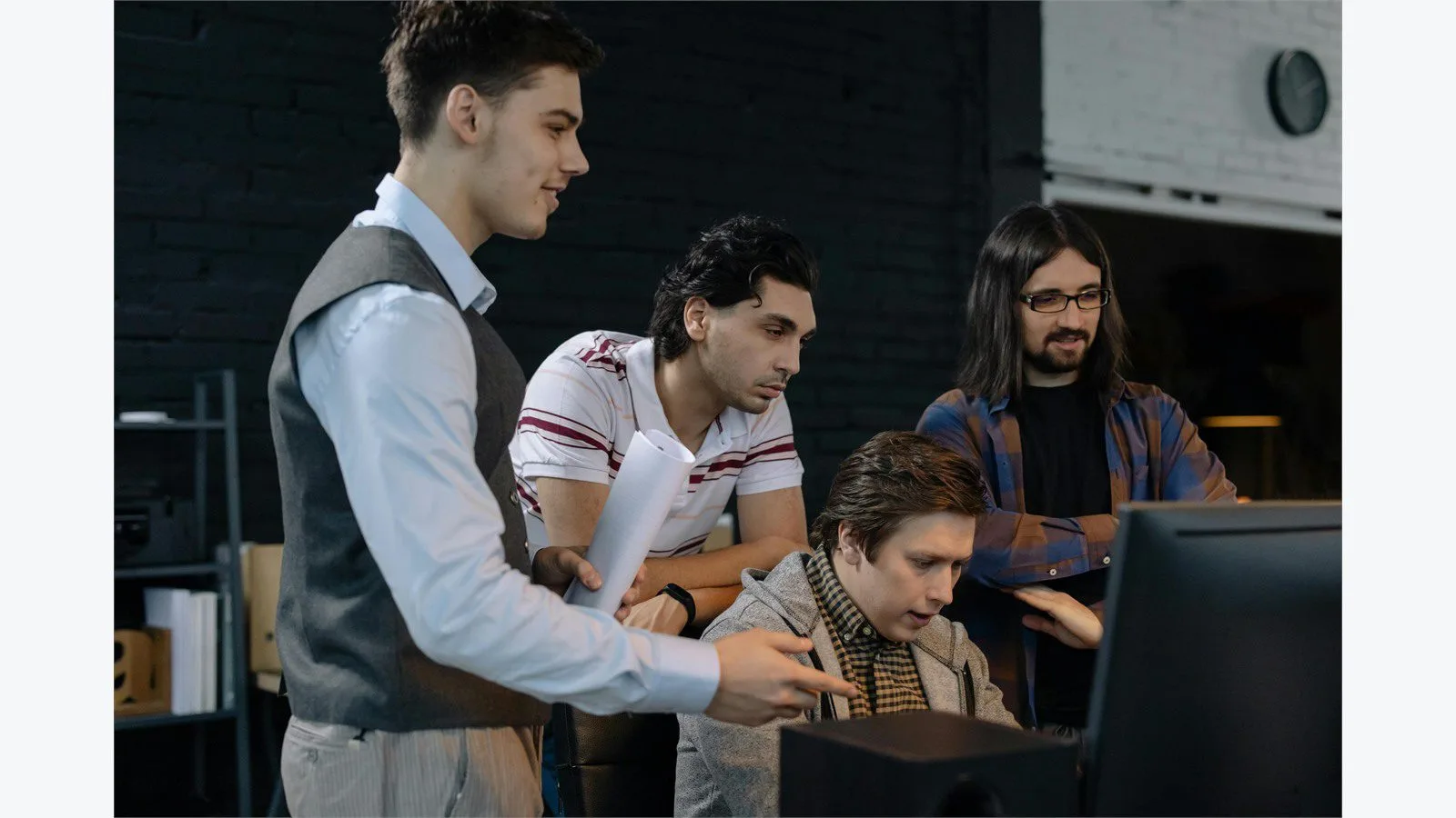 Engineering team discussing Java concurrency questions at a shared workstation