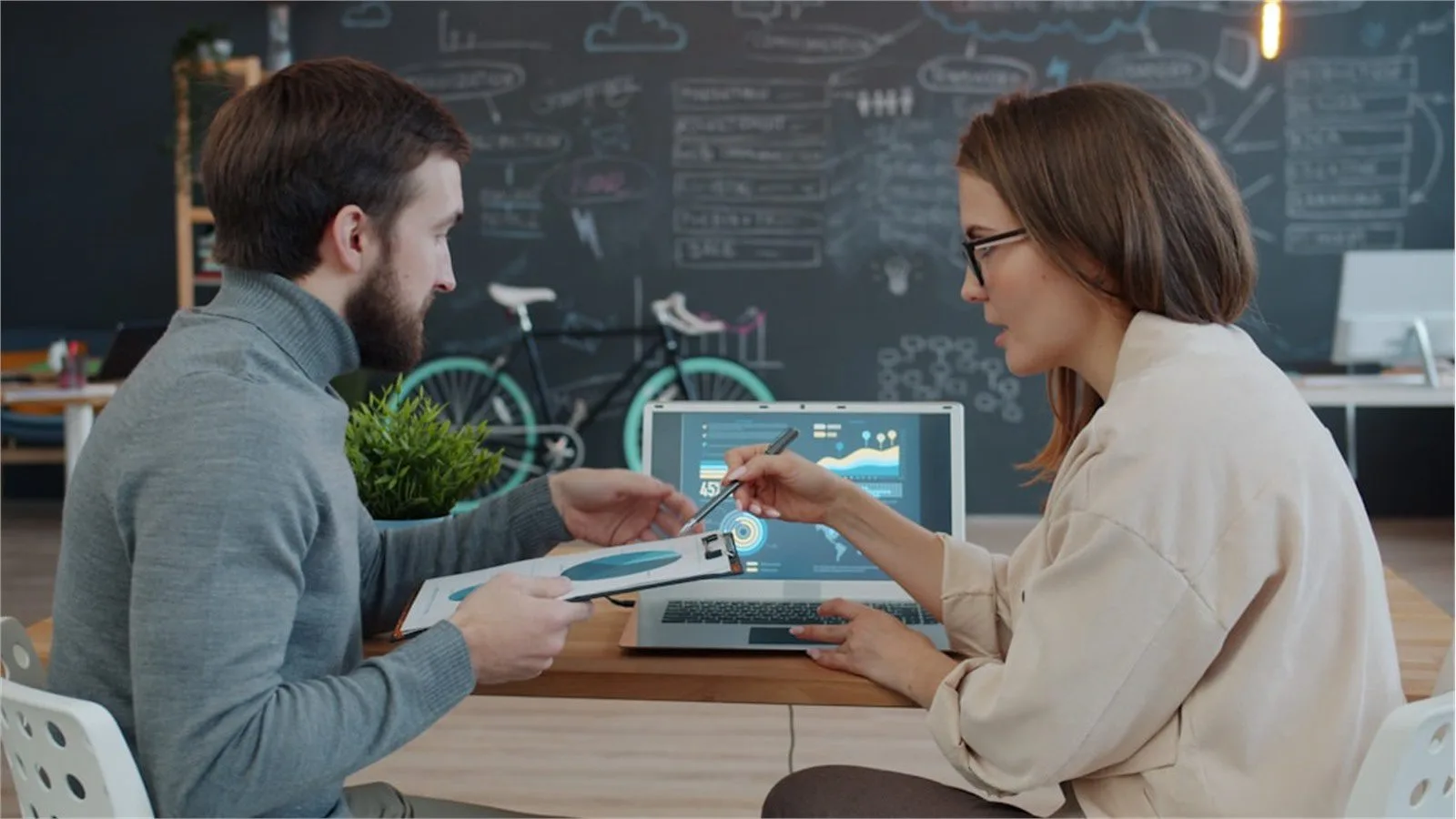 Browser Harness: 7 Powerful Reasons It Matters 15 Two colleagues reviewing laptop findings while answering common Browser Harness questions
