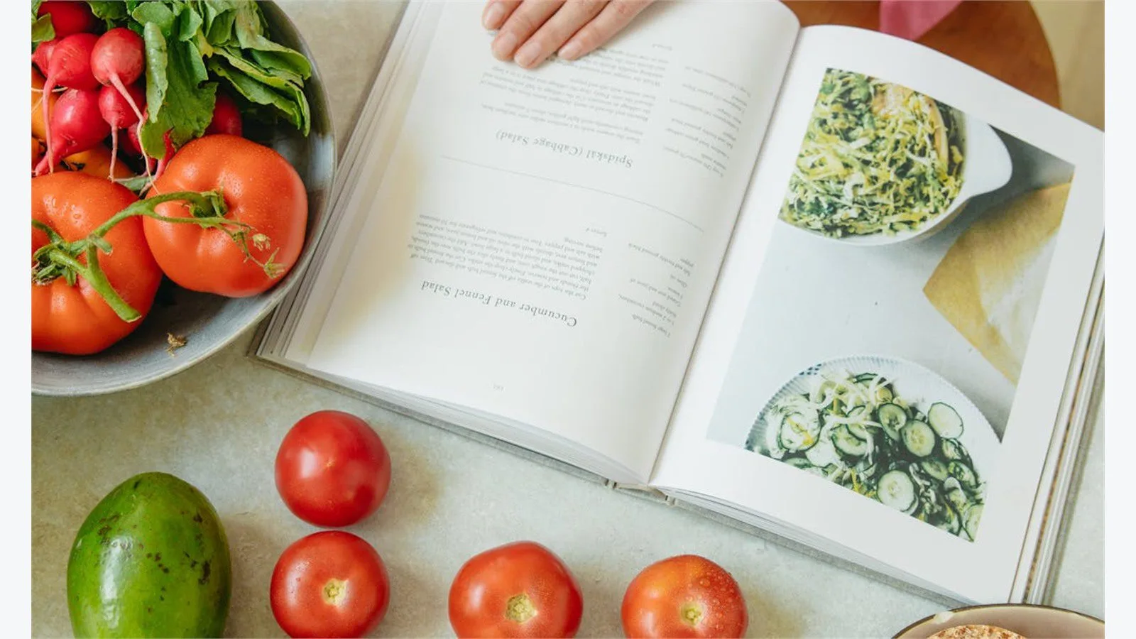 CalBye Review: 9 Smart Features for Better Nutrition 17 CalBye FAQ concept with an open cookbook and fresh vegetables on a kitchen counter