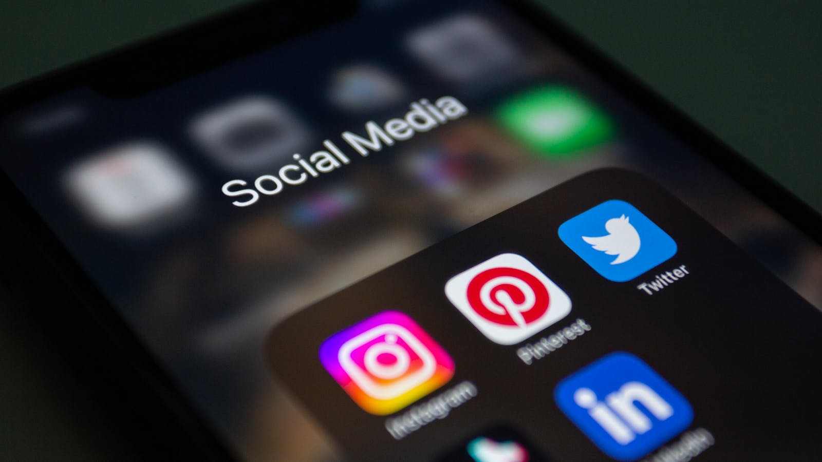 Social media apps on a phone showing channels criminals may mimic in brand identity attacks