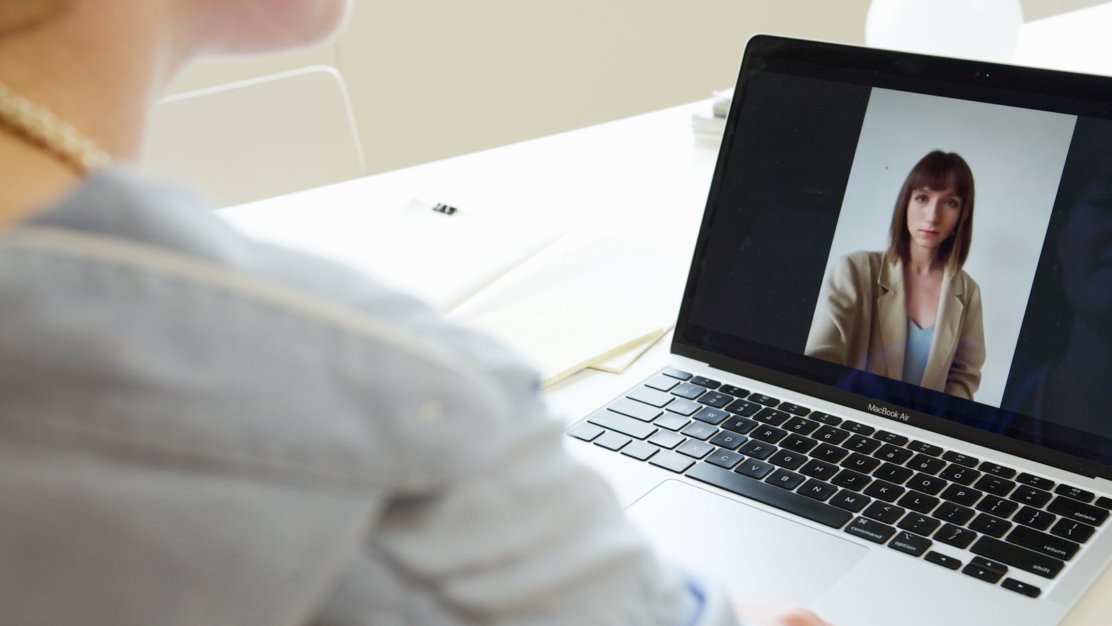Laptop video call representing deepfake social engineering and brand impersonation risk