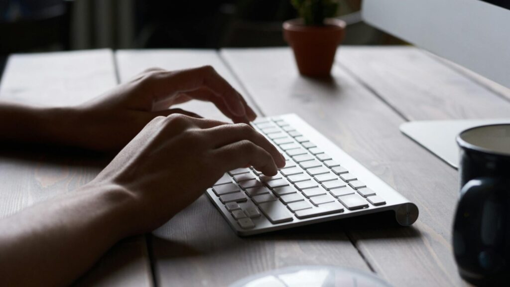 GPT-5.5 Instant memory controls shown as a professional typing on a keyboard for data context management