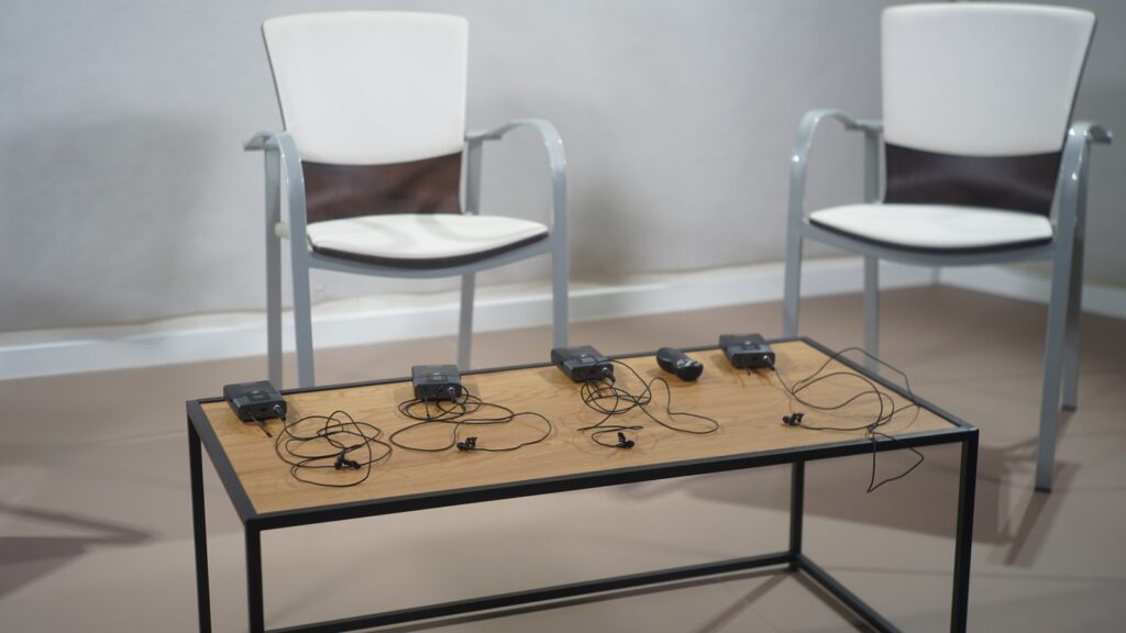 GPT-Realtime-2 Voice Agents shown by lavalier microphones ready for a live conversation
