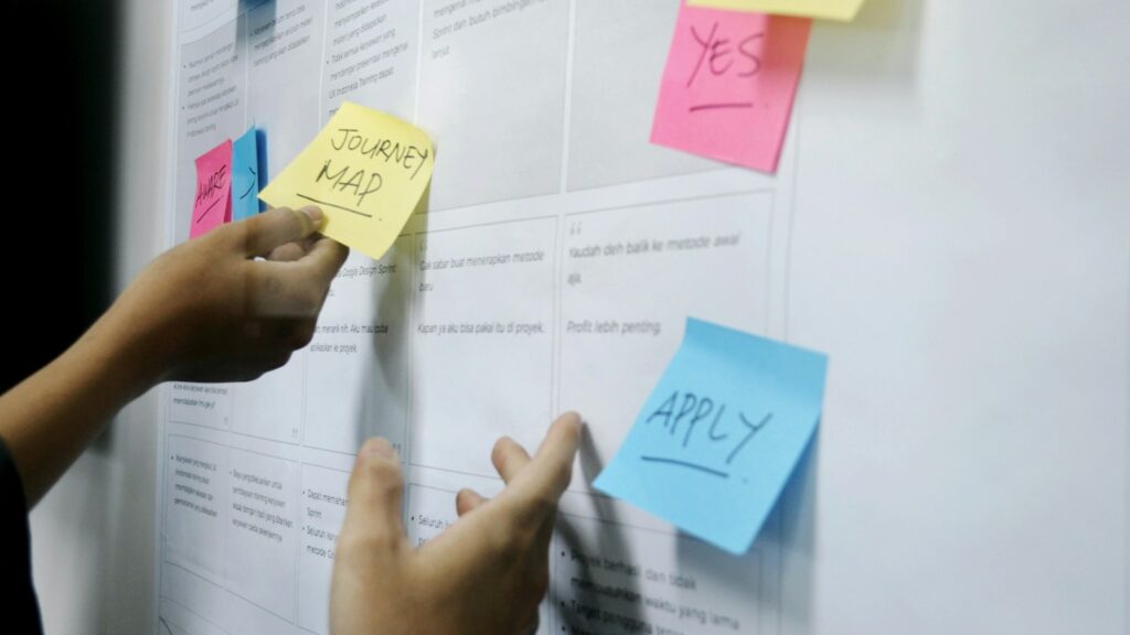 Person arranging sticky notes for digital workplace accessibility governance